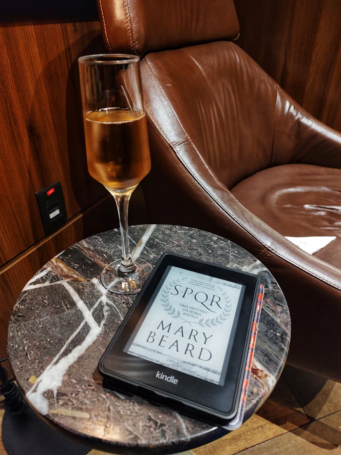 services-img Luxurious setting with a Kindle e-reader and a glass of champagne on a marble side table.